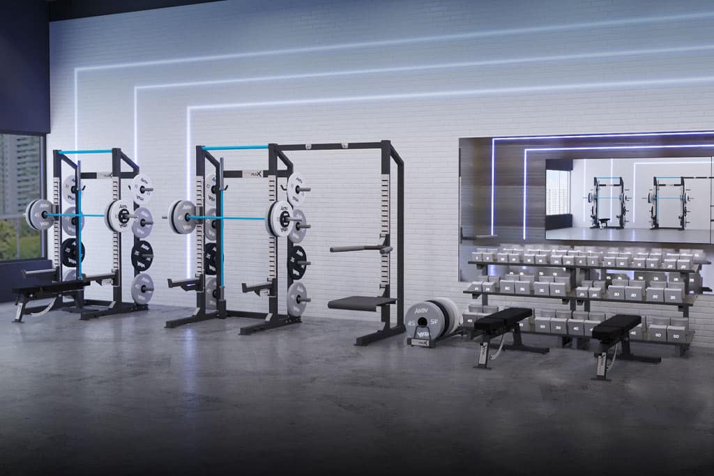 Forma-strength-training-fitness-equipment Two squat racks and a free weight strength training area with dumbbells and two benches.